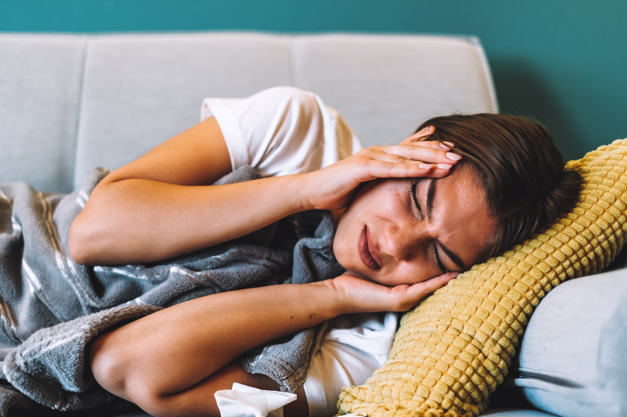 Tired young female touching forehead having headache migraine or depression